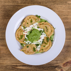 Ukrainian and Russian dish vareniki with mashed potatoes and sour cream. Close up. Top view