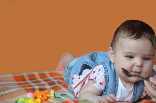 Cute Baby Playing With Silver Spoon, Baby Food, Baby Mashed In A Glass Jar With