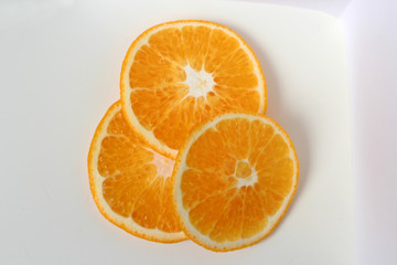 Orange sliced in circles three pieces on a white background isolate orange large