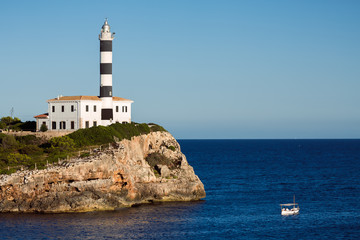 Fototapeta na wymiar Portocolom Lighthouse at Punta de ses Crestes, Portocolom, Mallorca. Spain.