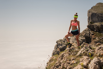 Sport Woman Traveler on a top of a mountain