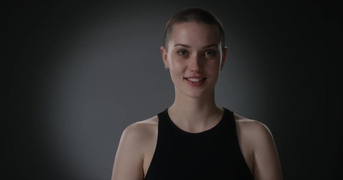 Young short haired woman slowly starts laughing