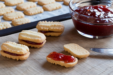 Preparation of Christmas cookies - filling the cookies with jam