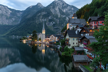 Fototapeta na wymiar Scenic picture-postcard view of famous historic Hallstatt mountain village with Hallstattersee in the Austrian Alps in mystic twilight during blue hour at dawn in summer, Salzkammergut region, Austria