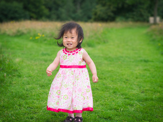 baby girl playing  in summer garden