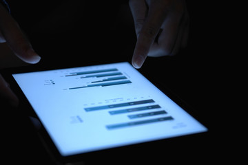 Close-up of the chart on the tablet's screen in dark illumination
