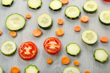 Top view of vegetables - zucchini, tomatoes, cucumbers, carrots.
