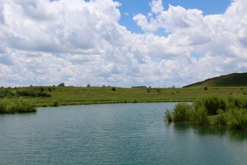 A view of the lake and the park landscape from the shore of the lake.