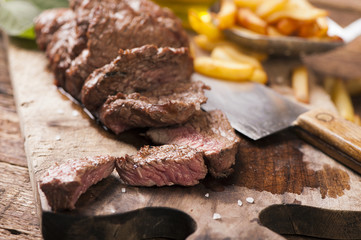 Delicious beef steakes on wood