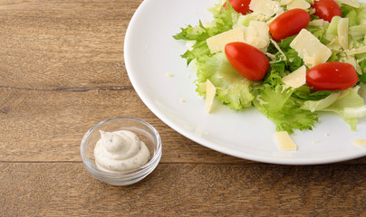Fresh salad parmesan on a wooden background