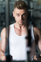 Fototapeta na wymiar Young Man Exercising Back In The Gym