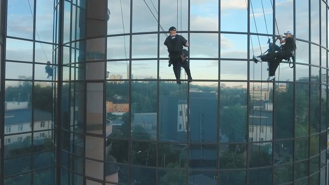 Professional climbers are working in front of business center