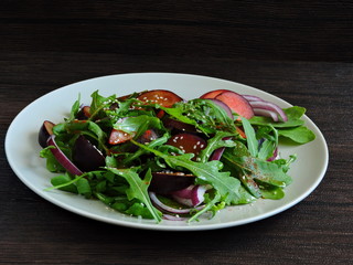 Delicious and healthy salad with plums. Copy space.