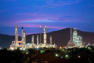 Naklejka premium Landscape of oil refinery industry with oil storage tank in night.