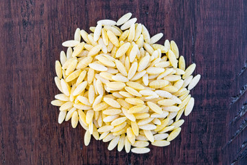 Orzo pasta wood background