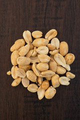 Dry roasted peanuts wood background
