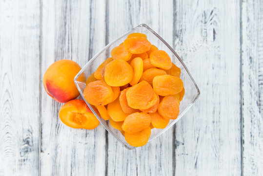 Apricots (dried) on wooden background (selective focus)