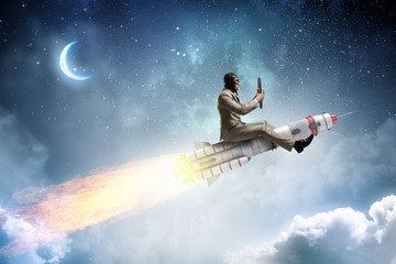 Obraz na płótnie Canvas Aviator riding rocket. Mixed media