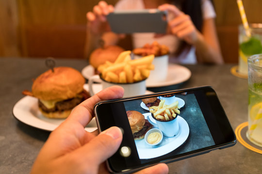 Taking photo on cellphone in restaurant