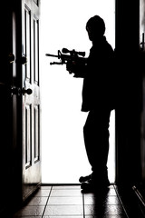 Intruder at door, in silhouette with AR-15 rifle