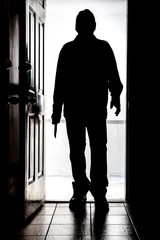 Intruder at door, in silhouette with buck knife