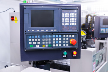 CNC machine with controller console in factory