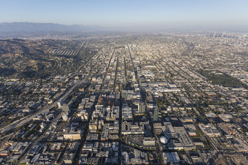 Fototapeta premium Smoggy afternoon aerial view of Hollywood and downtown Los Angeles in Southern California.