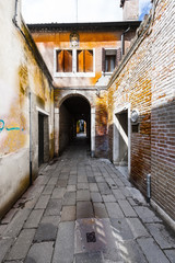 Fototapeta na wymiar Street with archway in Venice