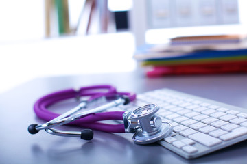 medical stethoscope with a computer on the desk