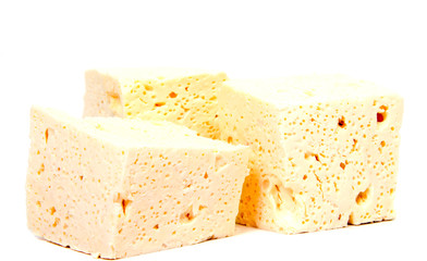 Sliced fresh white cheese from cow's milk on white background