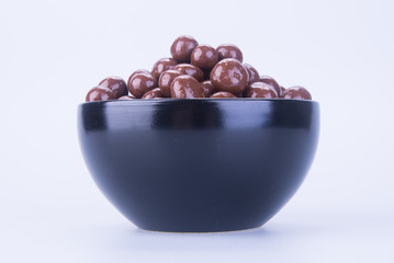 chocolate balls. chocolate balls in bowl on a background