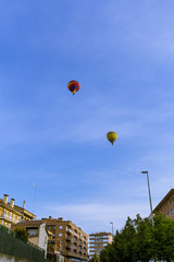 Fototapeta na wymiar Two balloons flying over a blue sky