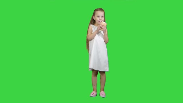 Kid girl eating ice cream on a Green Screen, Chroma Key