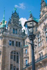 Fototapeta na wymiar Old lantern in front od Hamburg City Hall Towers. Germany