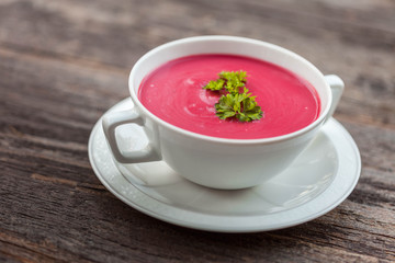 Velvety Beetroot and goat cheese soup on old black rustic table