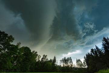 Obraz na płótnie Canvas Scarry dark storm clouds over forest