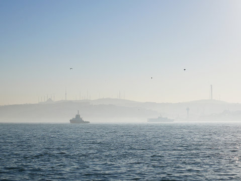 Foggy morning scenery of Istanbul's Bosphorus strait in Turkey. The canal divides Istanbul into Asia part and Europe part, and is a famous tourist spot to take cruise along the canal.
