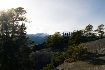 People on view point above mountains and bay and valley.