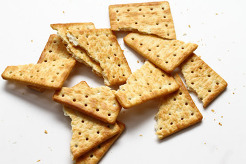 A cracker is a baked food typically made from flour. Flavorings or seasonings, such as salt, herbs, seeds, and/or cheese, may be added to the dough or sprinkled on top before baking