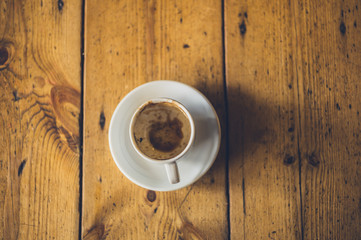 Empty cup of coffee on wooden table