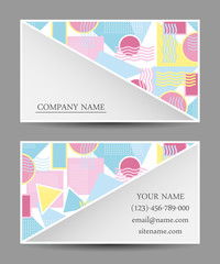 A set of business cards with a bright modern geometric pattern.