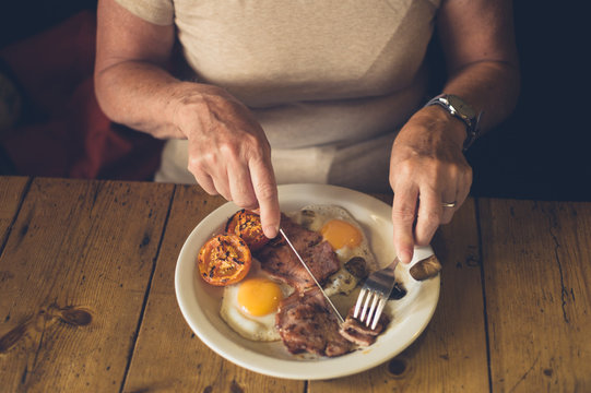 Senior woman eating english breakfast