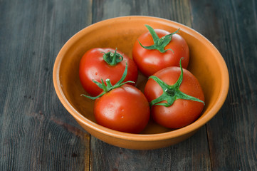 Juicy ripe tomatoes on a wooden table