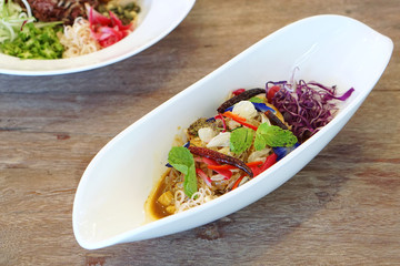 Pomelo salad thai style, mixed with purple cabbage, butterfly pea, torch ginger, chili and mint - Veganism Food is the practice of abstaining from the use of animal products.