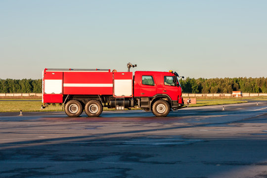 Red airfield fire engine at the airport apron