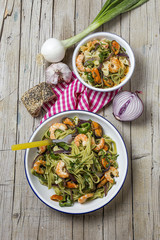 Green tagliatelle with seafood. Mussels; Prawns