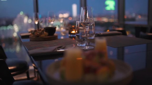 Modern restaurant, view of glasse goblets on the tabel, shallow depth of field. Interior lighting.
