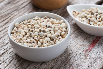 Job's tears in bowl on rustic wooden table