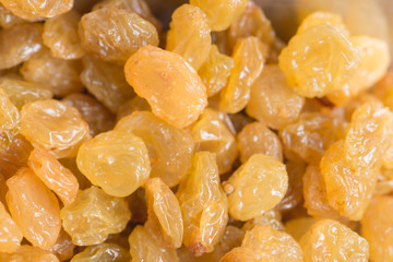 Dried yellow raisin fruits on  wood background