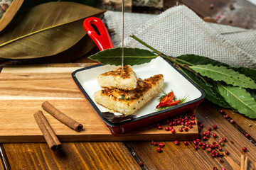 Fish cutlets on a wooden table water with syrup